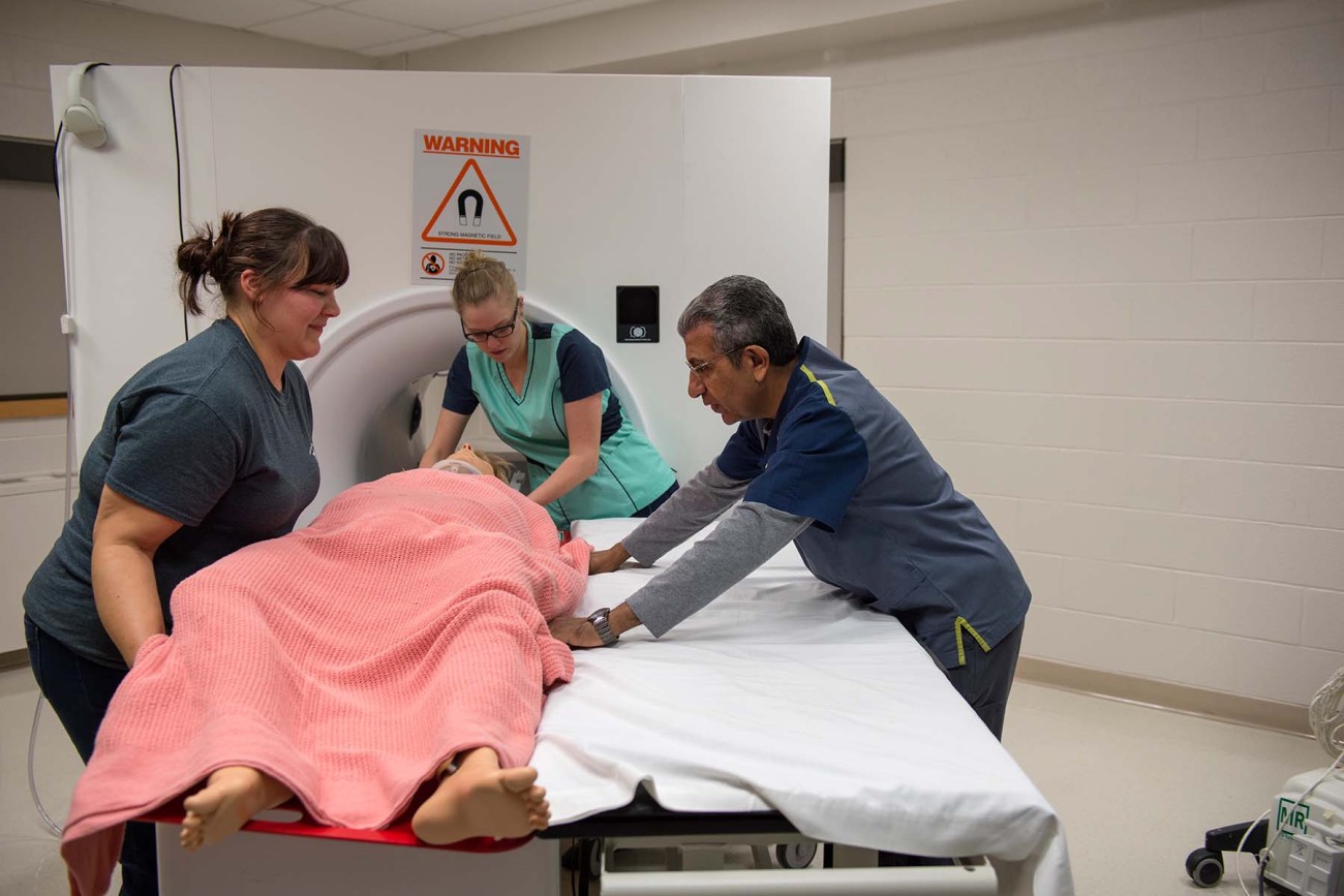 MRI Students helping transfer a patient to the mri table