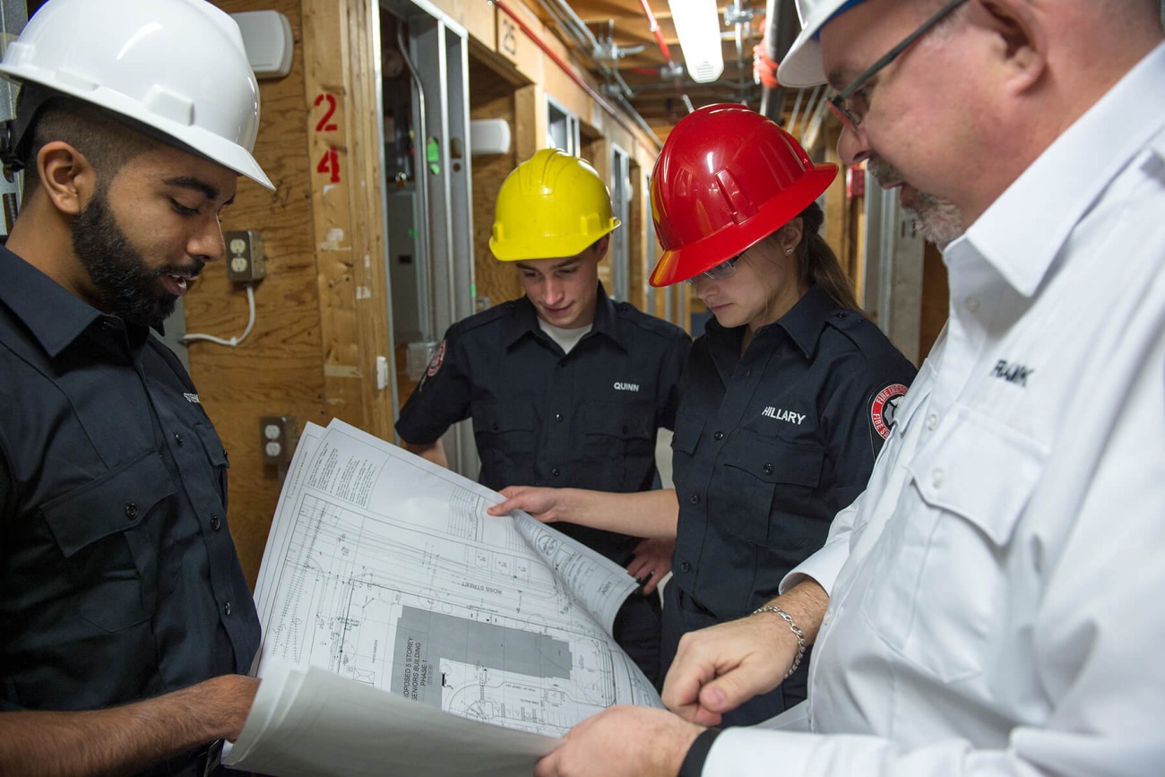 fire safety inspectors looking over schematics
