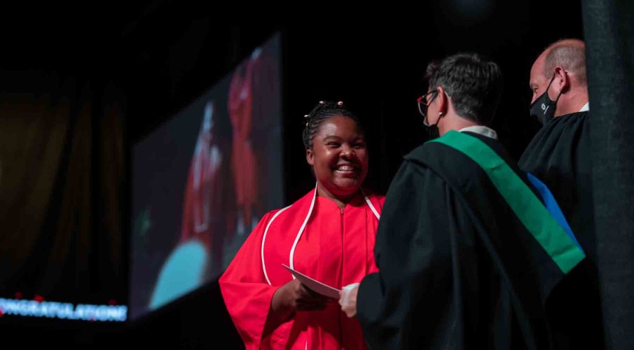 Student accepting diploma on stage at graduation
