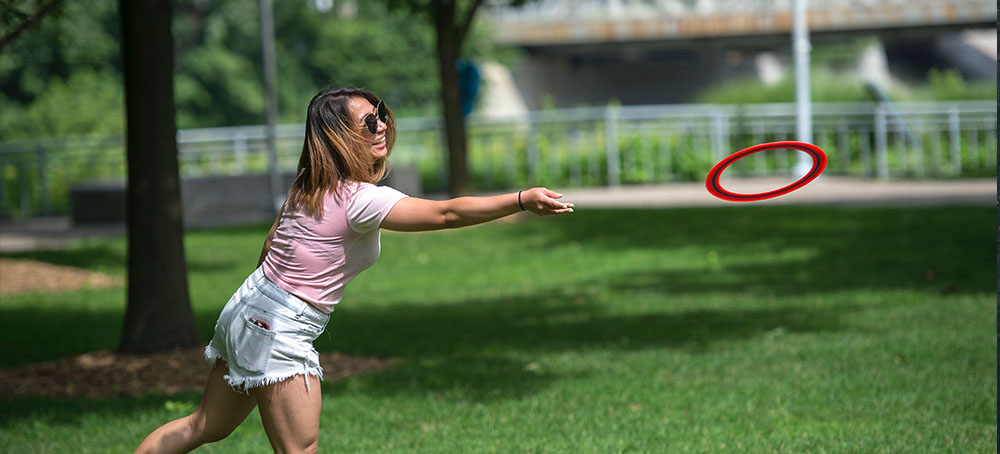 throwing a frisbee on campus