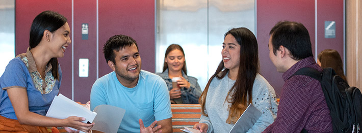 students sit around a table discussing college or university options