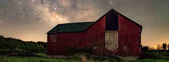 night sky with barn in the foreground