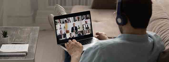 man attending virtual event on laptop