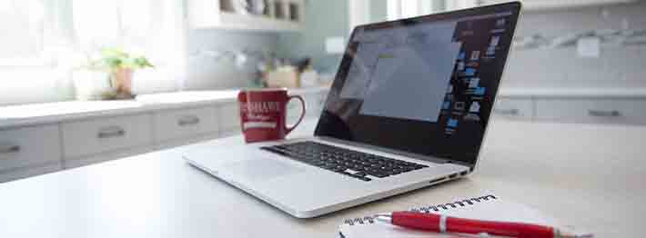 open laptop on kitchen counter