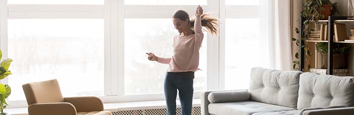 Women dances alone in her living room