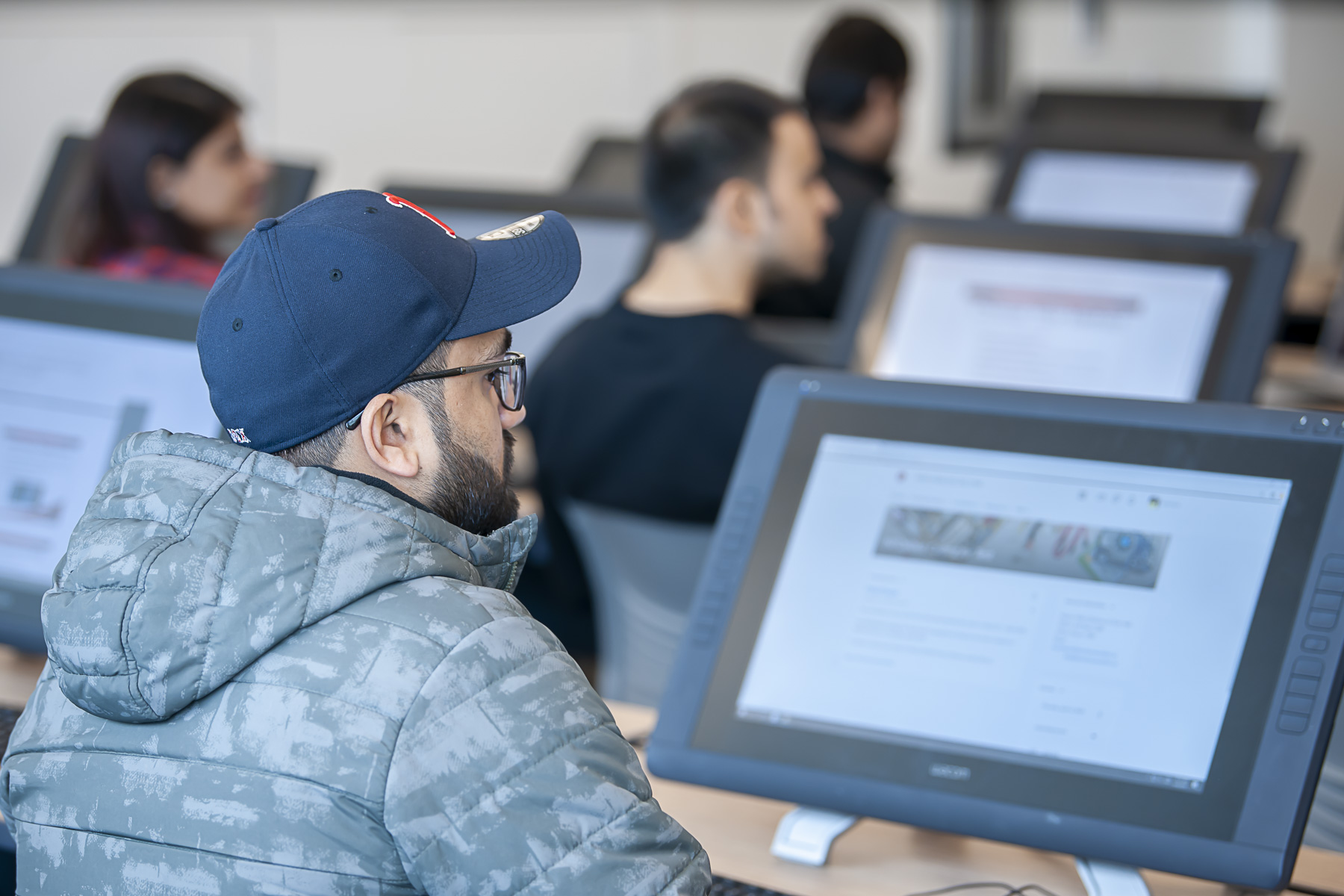 Software and Information Systems student on their computer in class