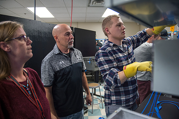 Electrical Engineering Technician students being taught by a faculty member