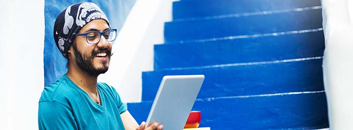College student exploring microcredentials on tablet