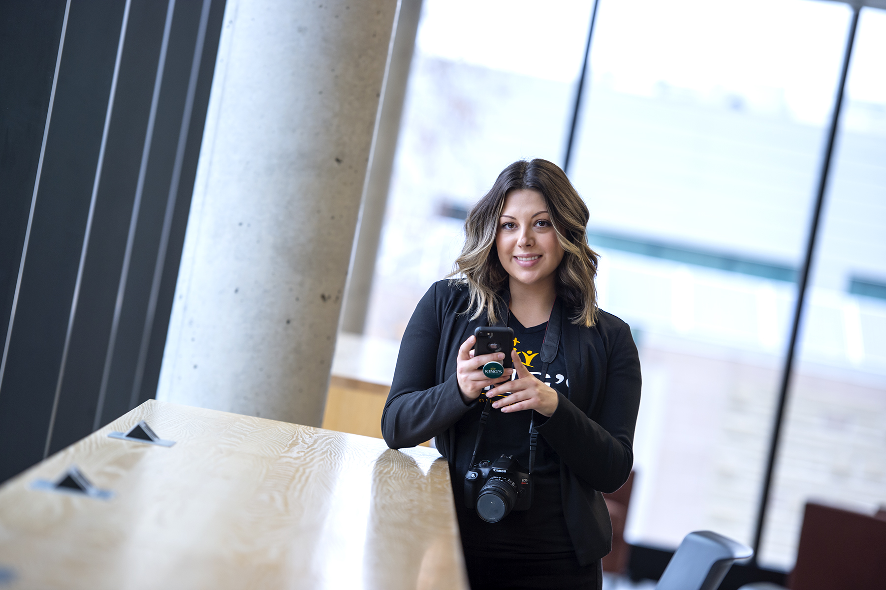 women at a desk on her phone