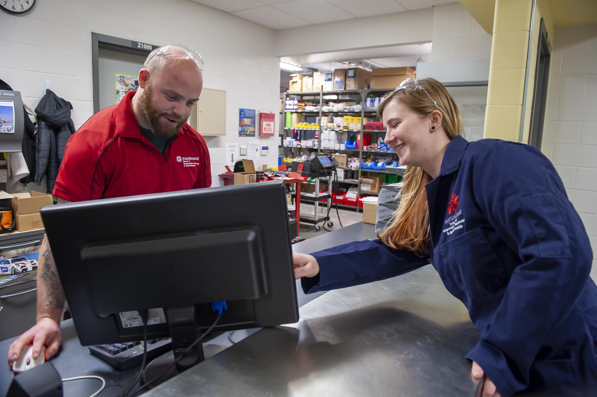 Two students working at automotive counter at Fanshawe College