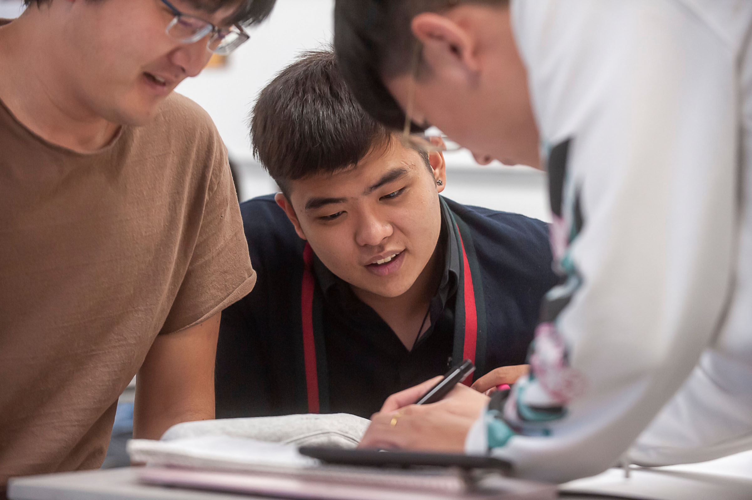 Three students working together on a paper