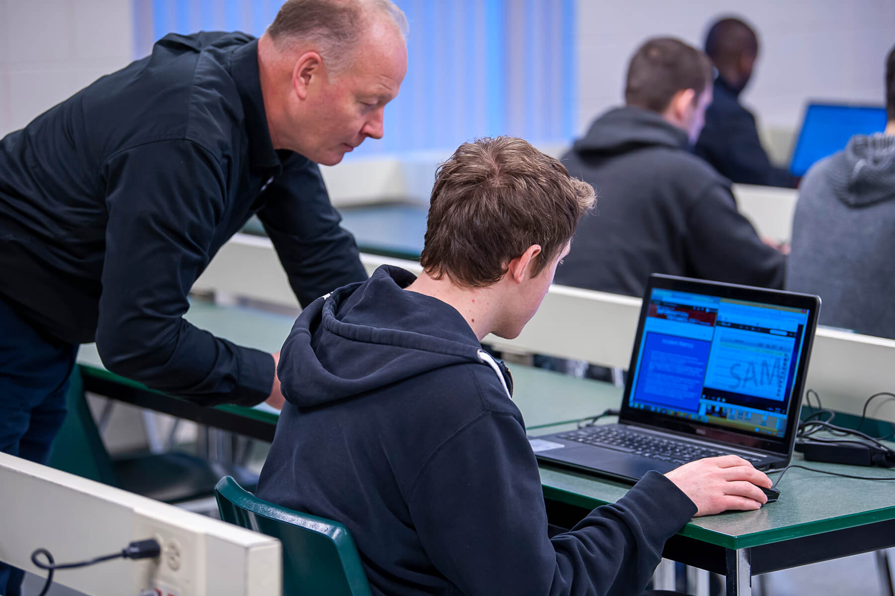 Faculty member helping student