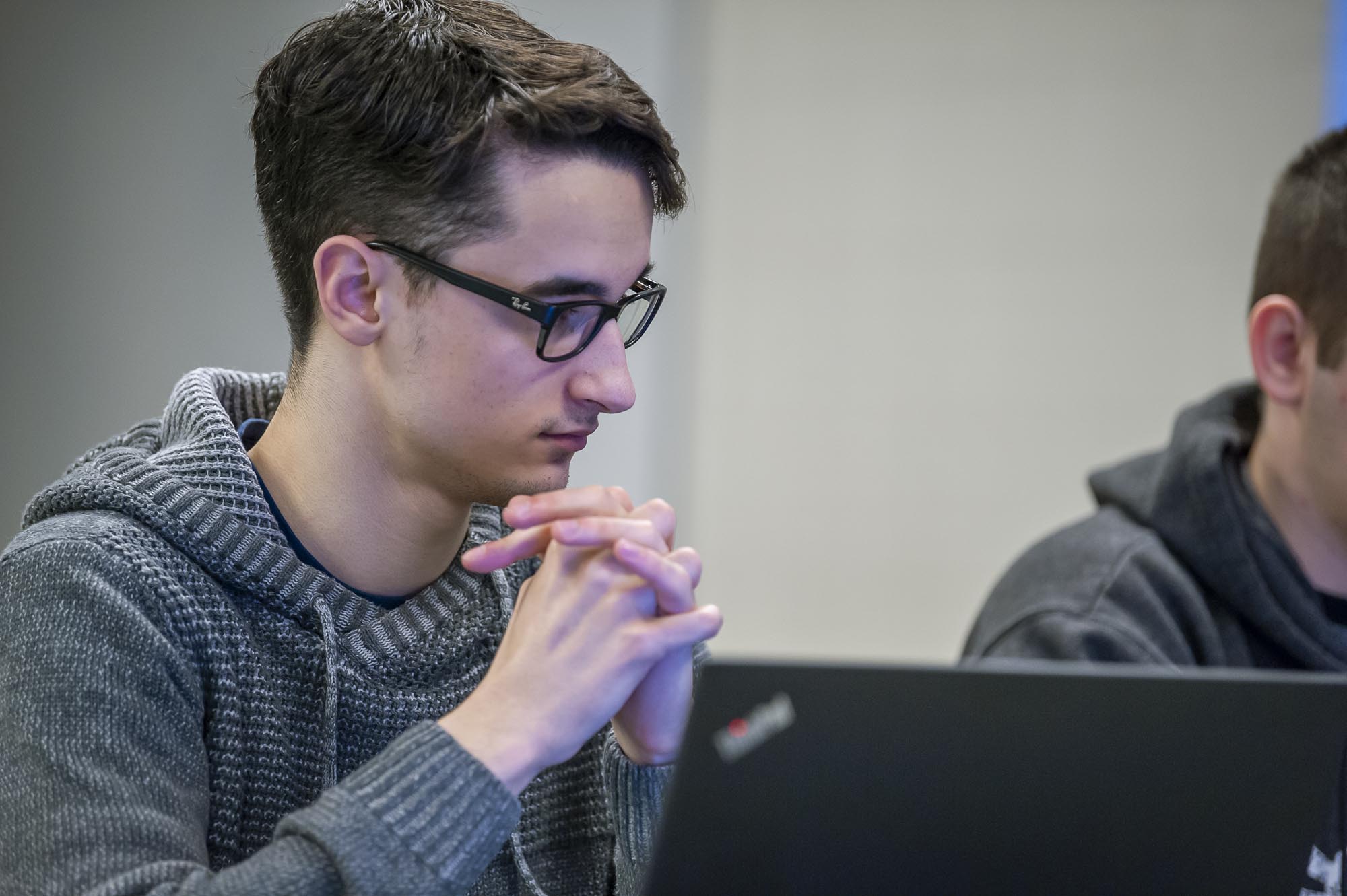 Student in computer lab, looking at laptop screen