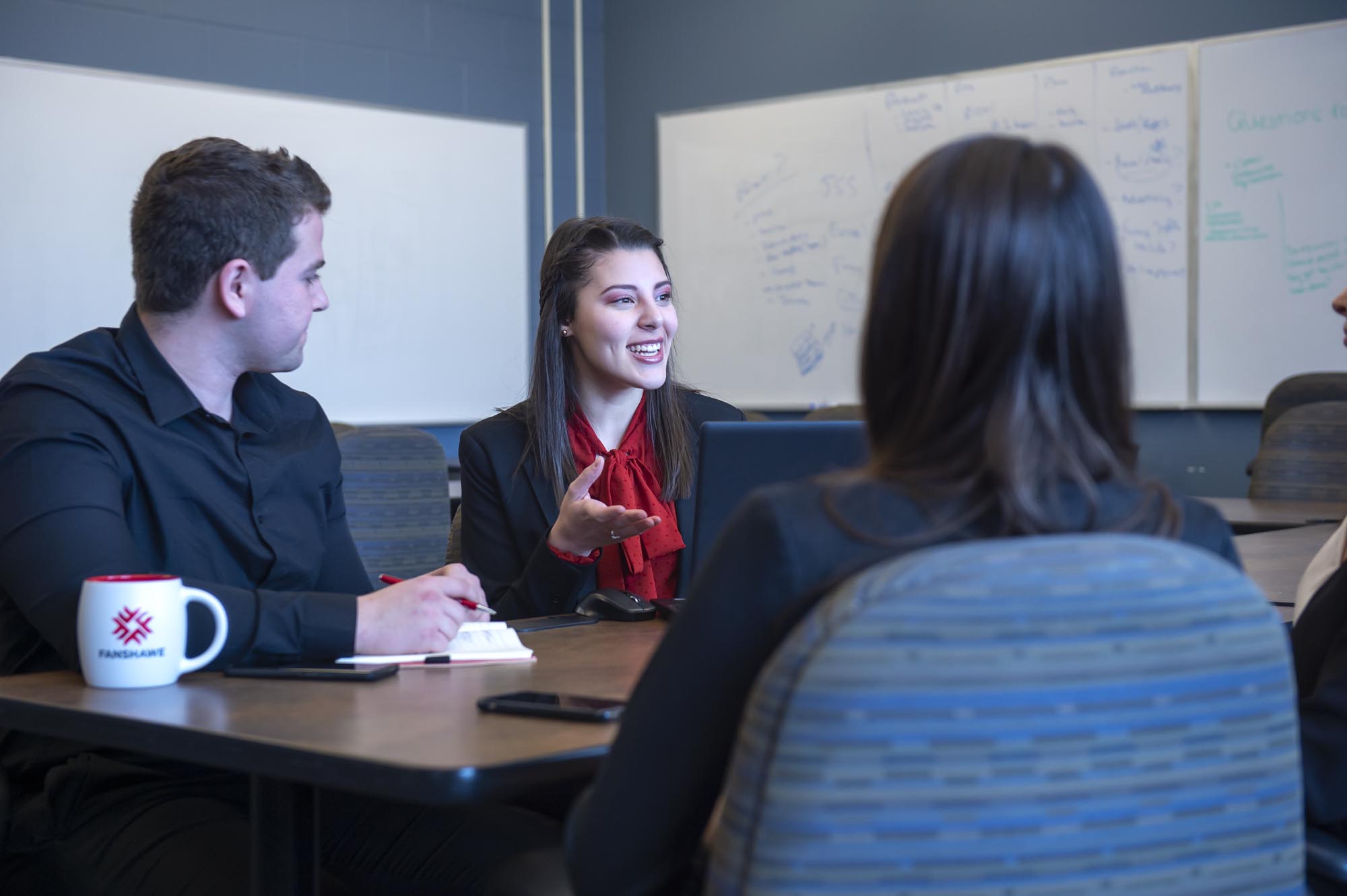Fanshawe business students, collaborating in conference room