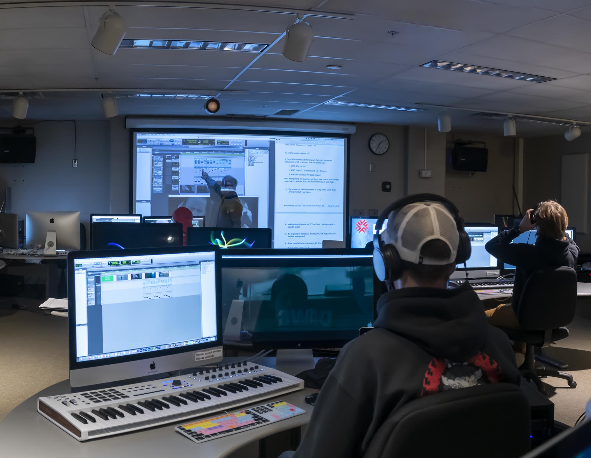 Students in class with professor at white board in audio post-production computer at Fanshawe Collegelab