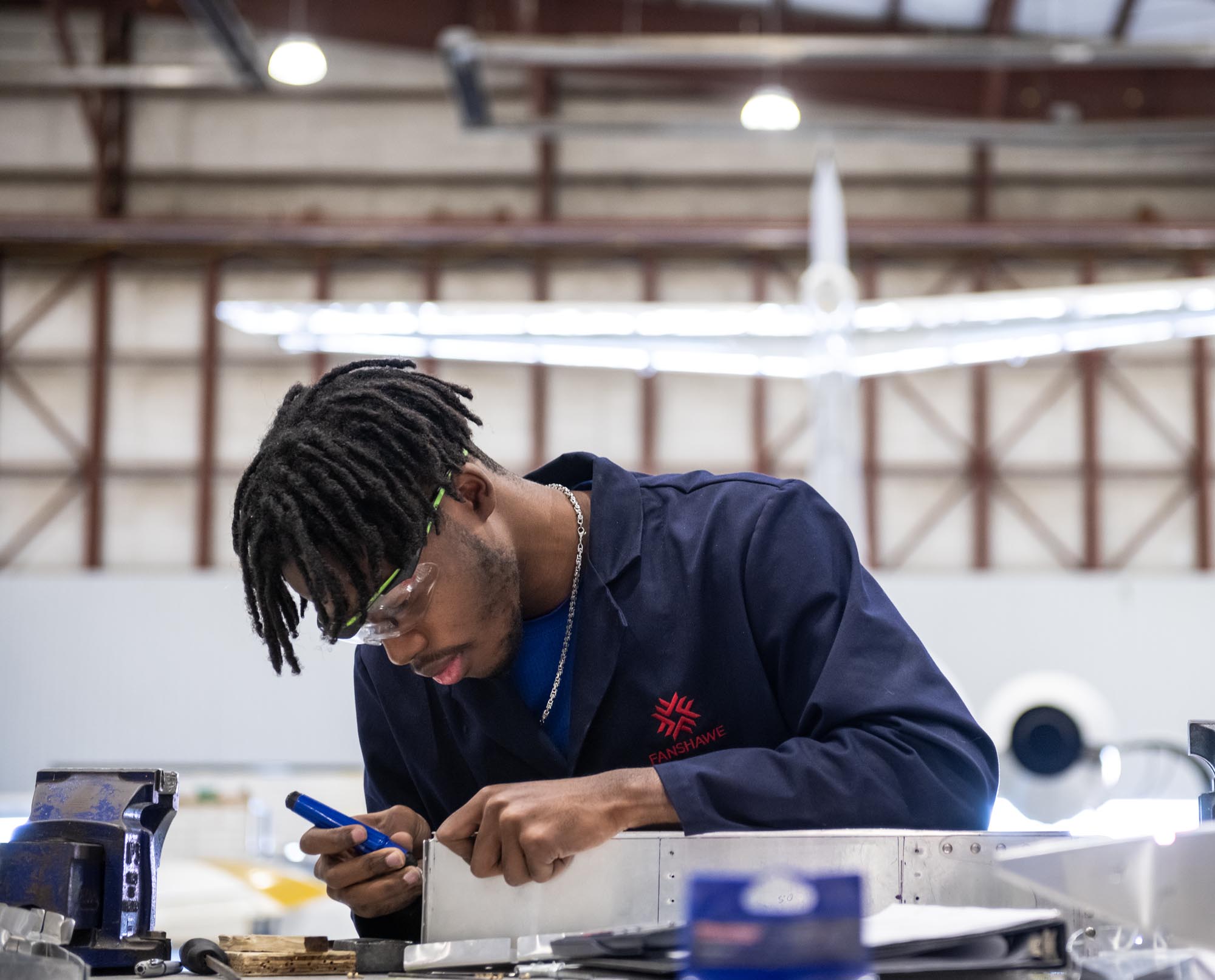 Aviation Technician Aircraft Maintenance student, working in class at hangar