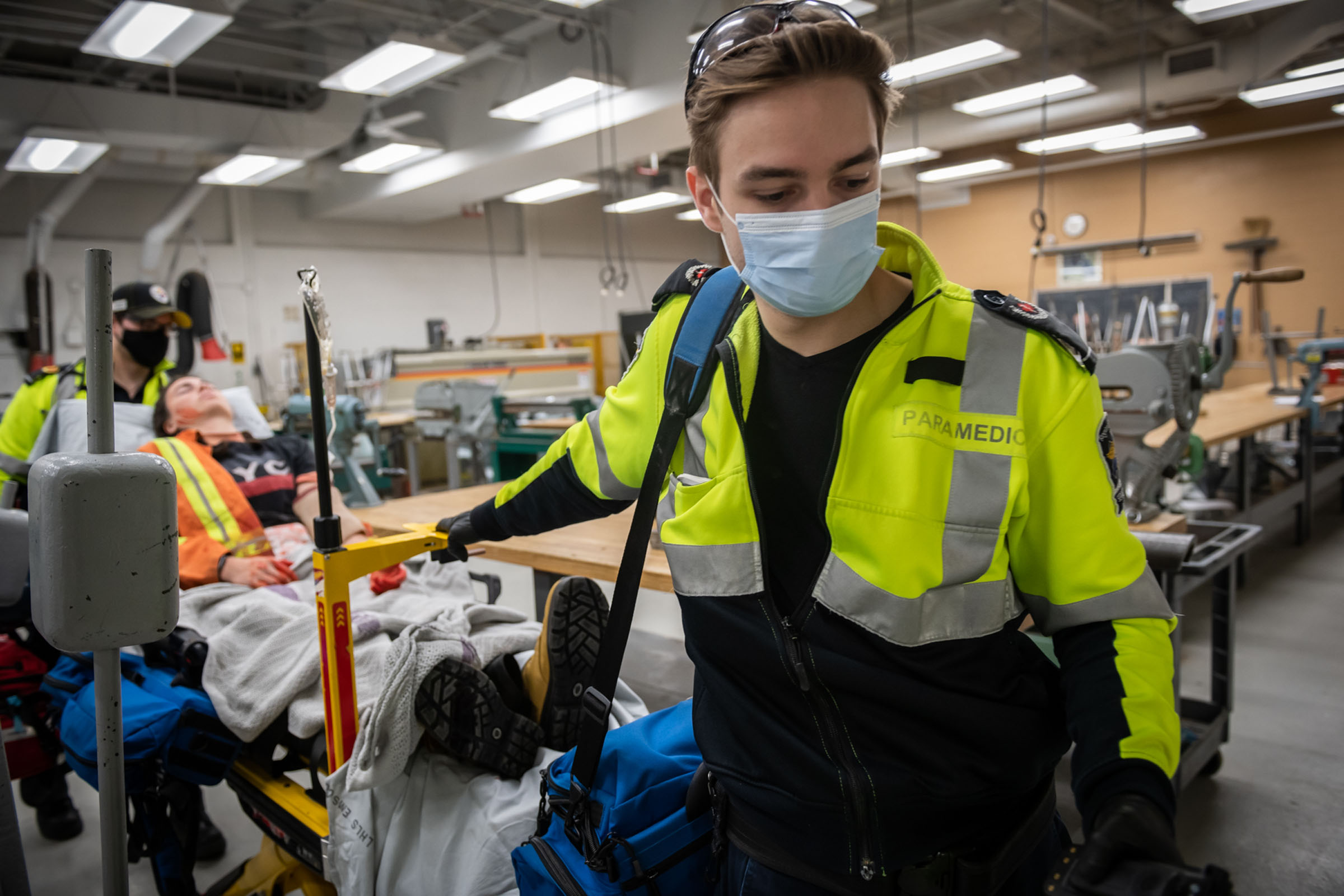 Paramedic student with practice patient on stretcher