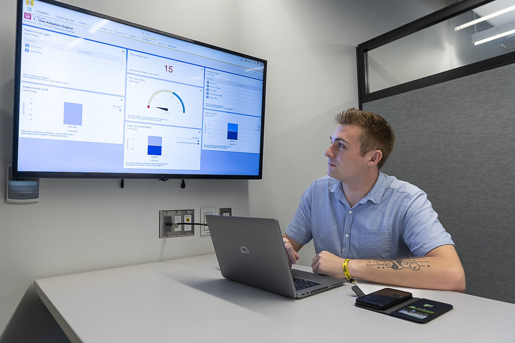 Student working on computer showing a presentation on screen