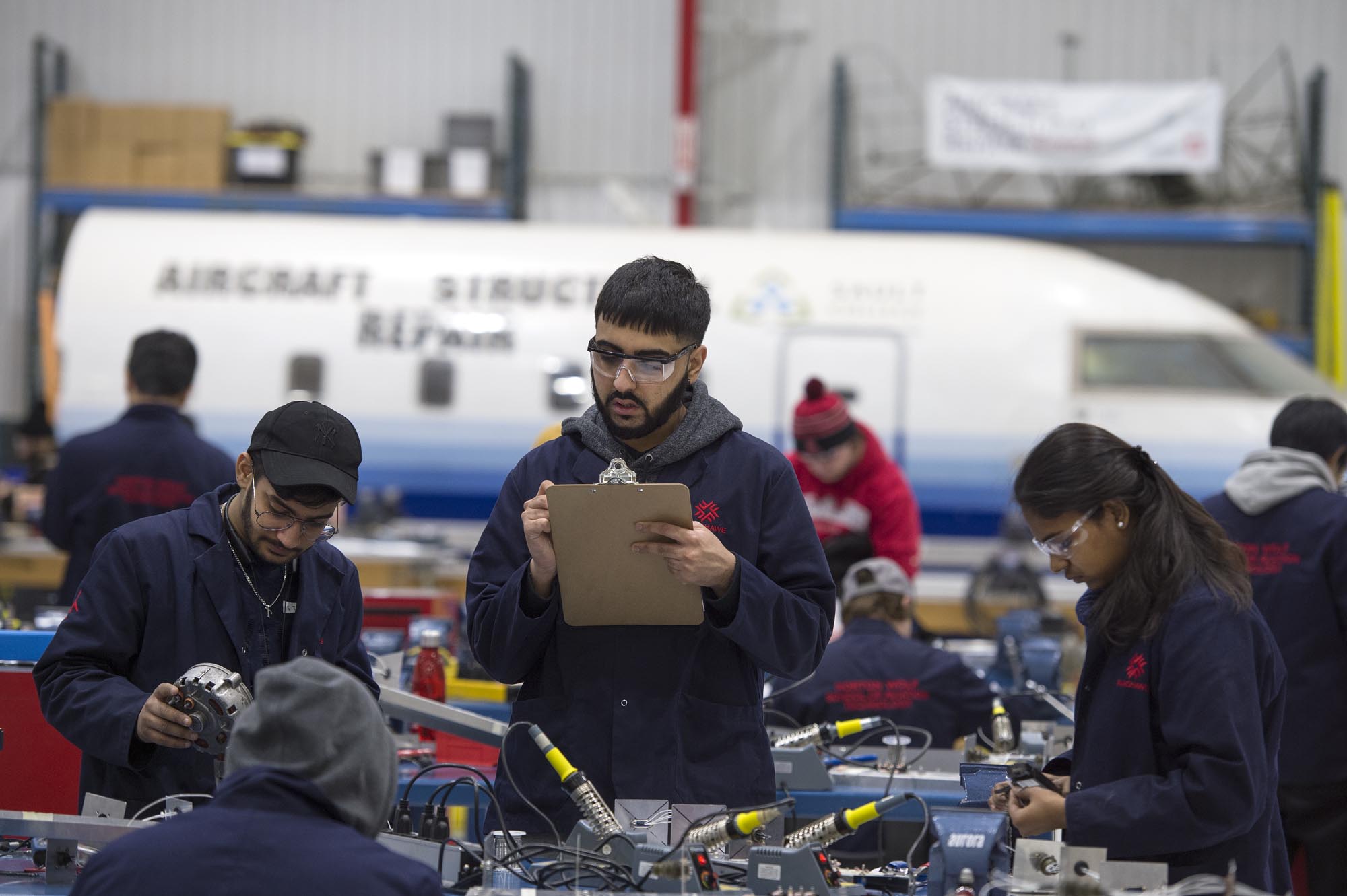 Aircraft Structural Repair Technician students working at the Jazz Hangar at Fanshawe College