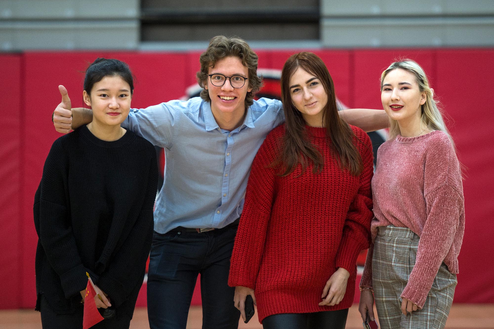 Group of four students smiling at camera