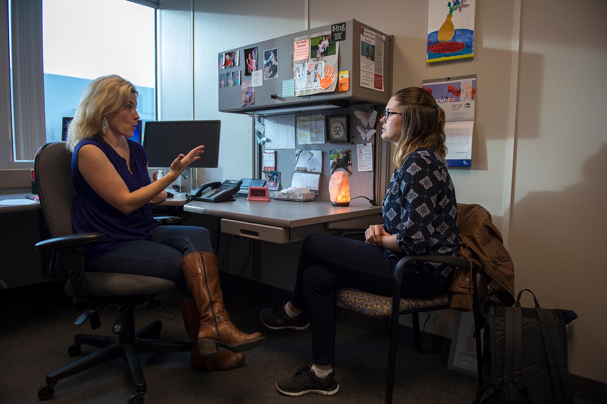 Student talking to counsellor in an office