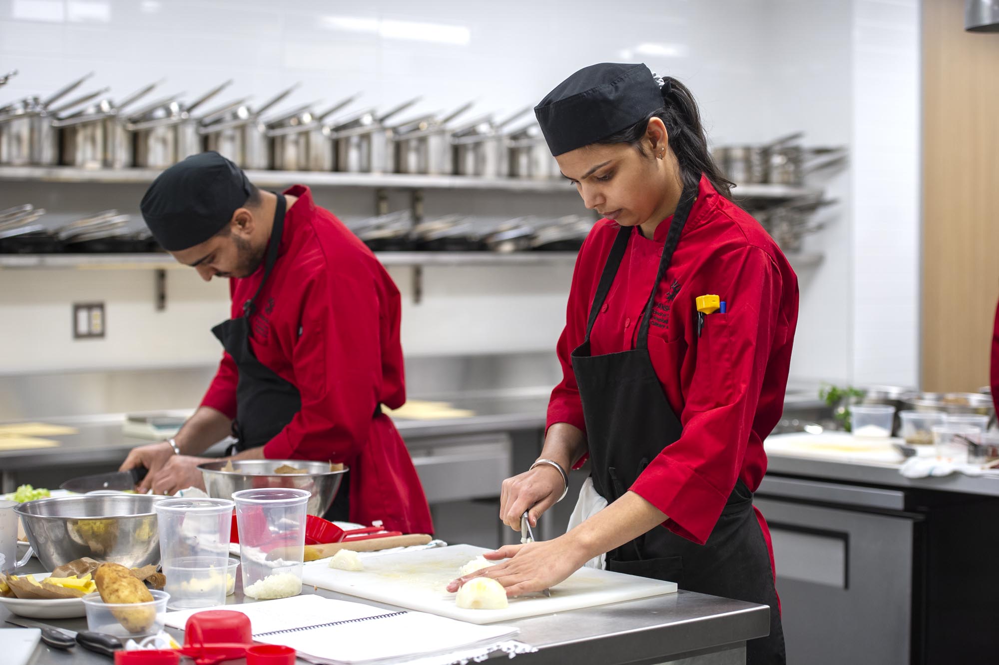 Culinary students preparing food in culinary lab