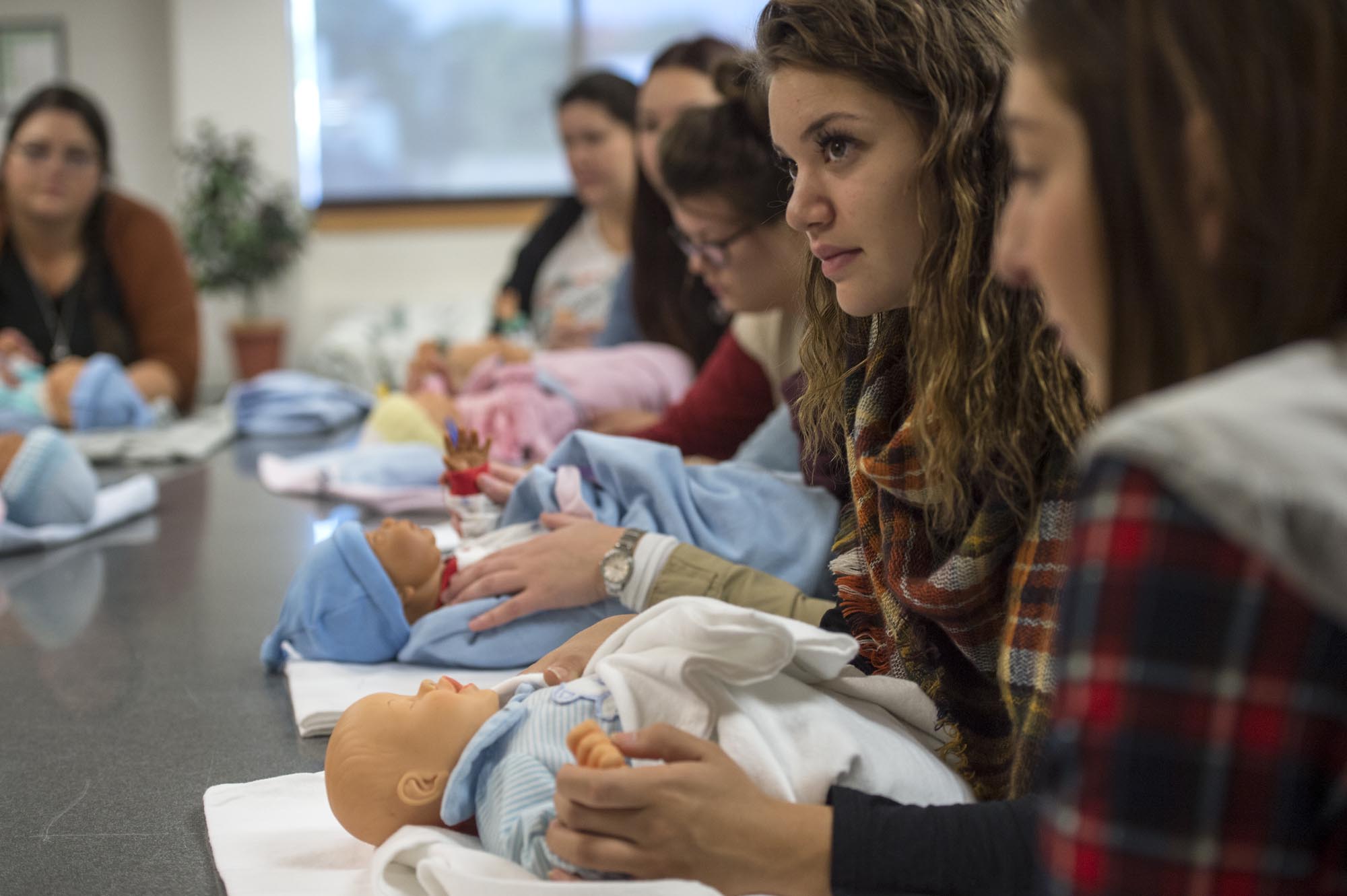 Students in doula class, paying attention to instructor