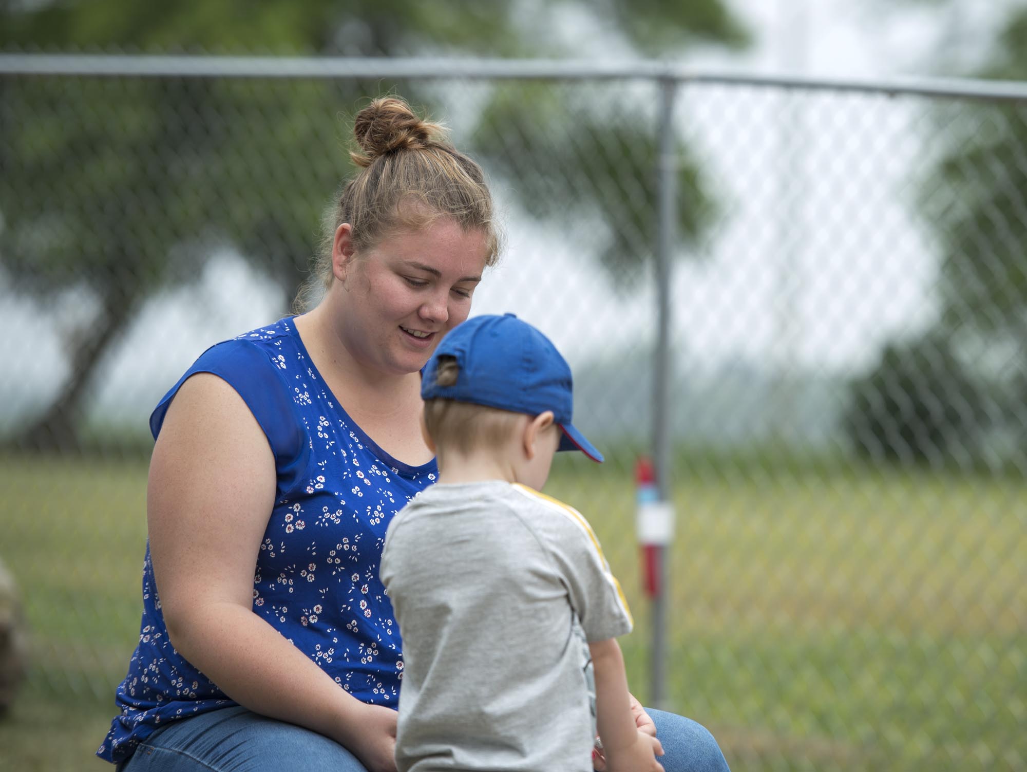 Student working with young child in outdoor daycare setting