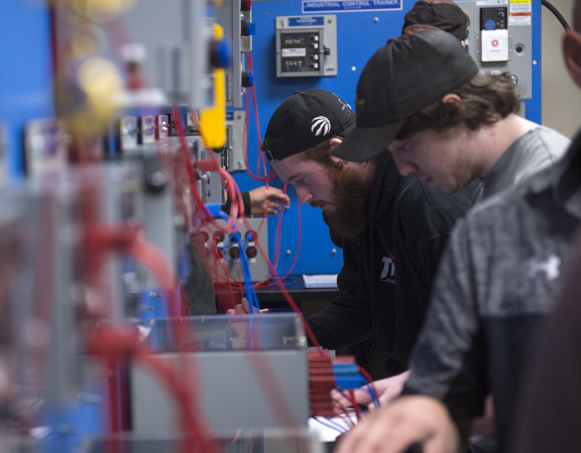 Students working in electronics lab at Fanshawe College with instructor assisting