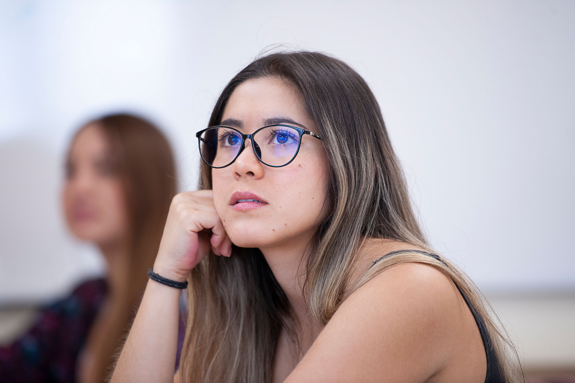 Student in class with curious look on her face