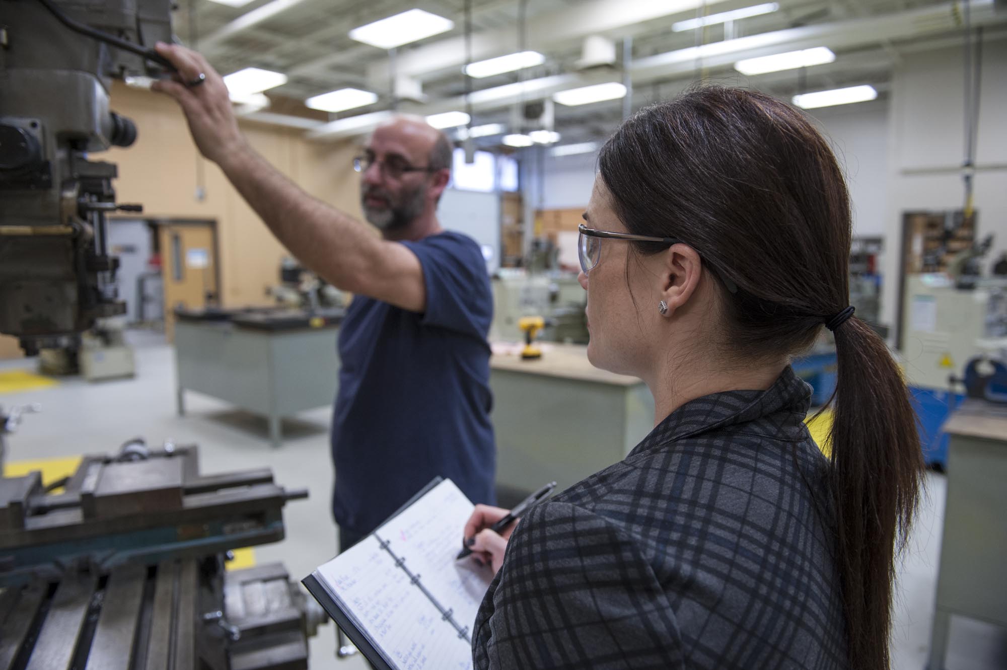 Person performing ergonomic assessment in workshop