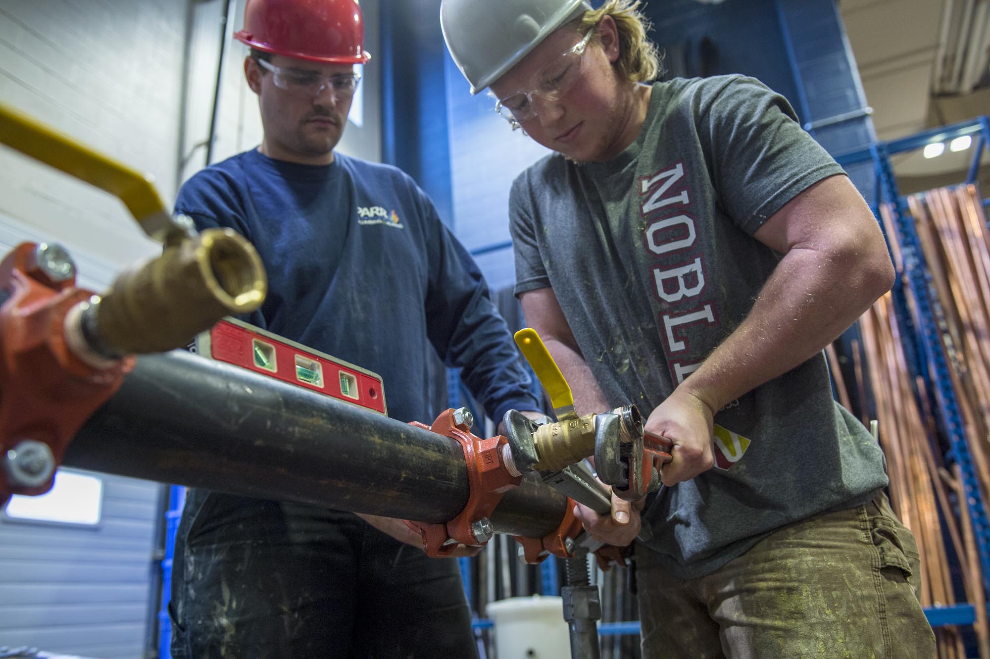 Fire Safety Systems students working on fire safety equipment