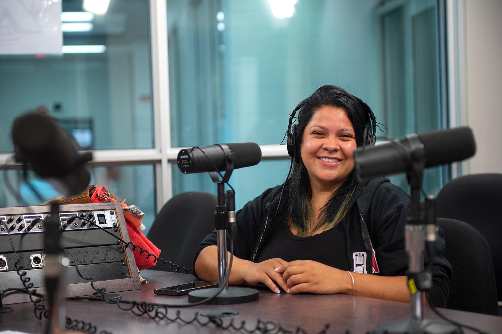 Student smiling in audio booth
