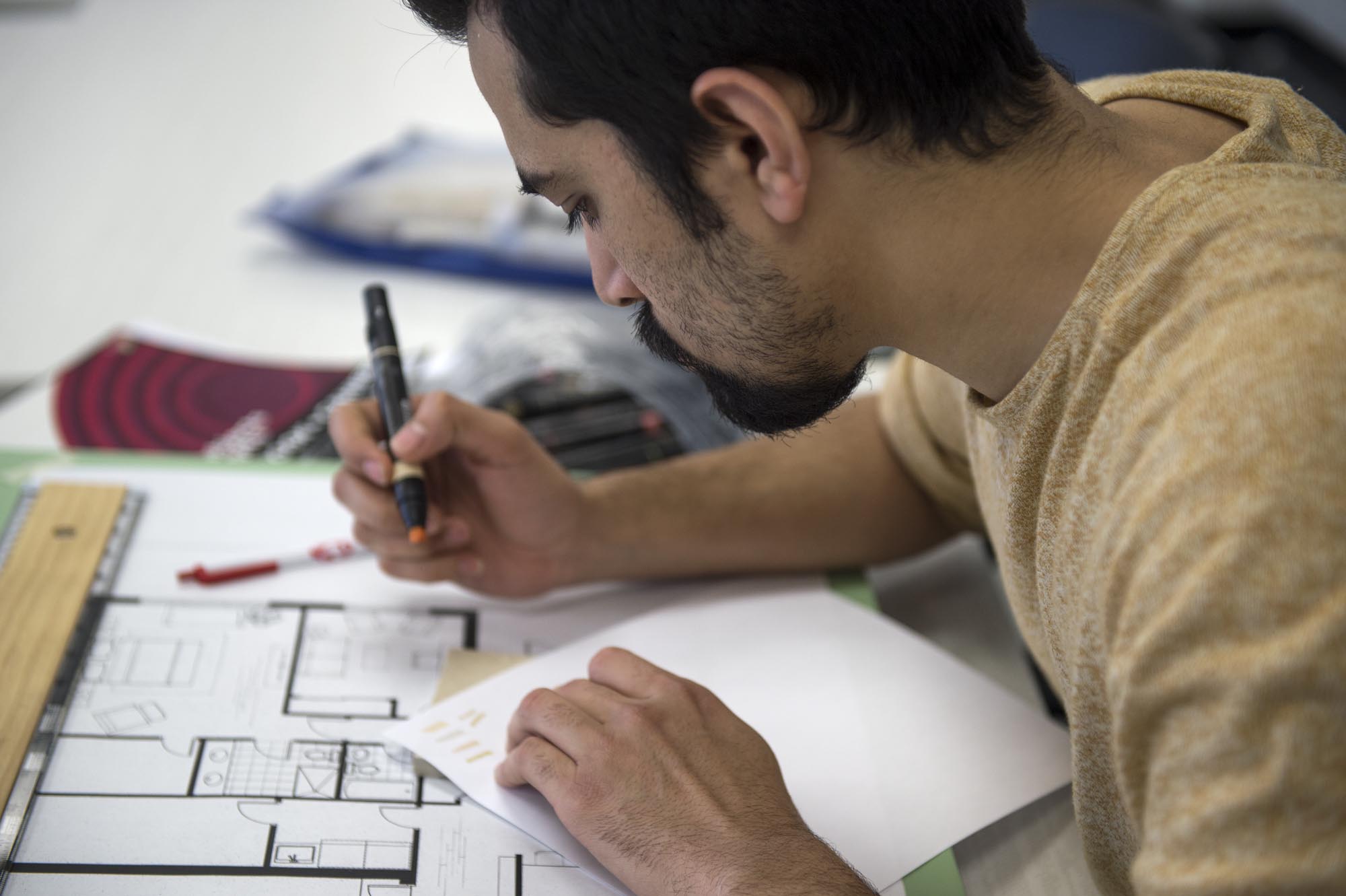 Student working on interior decorating assignment in class