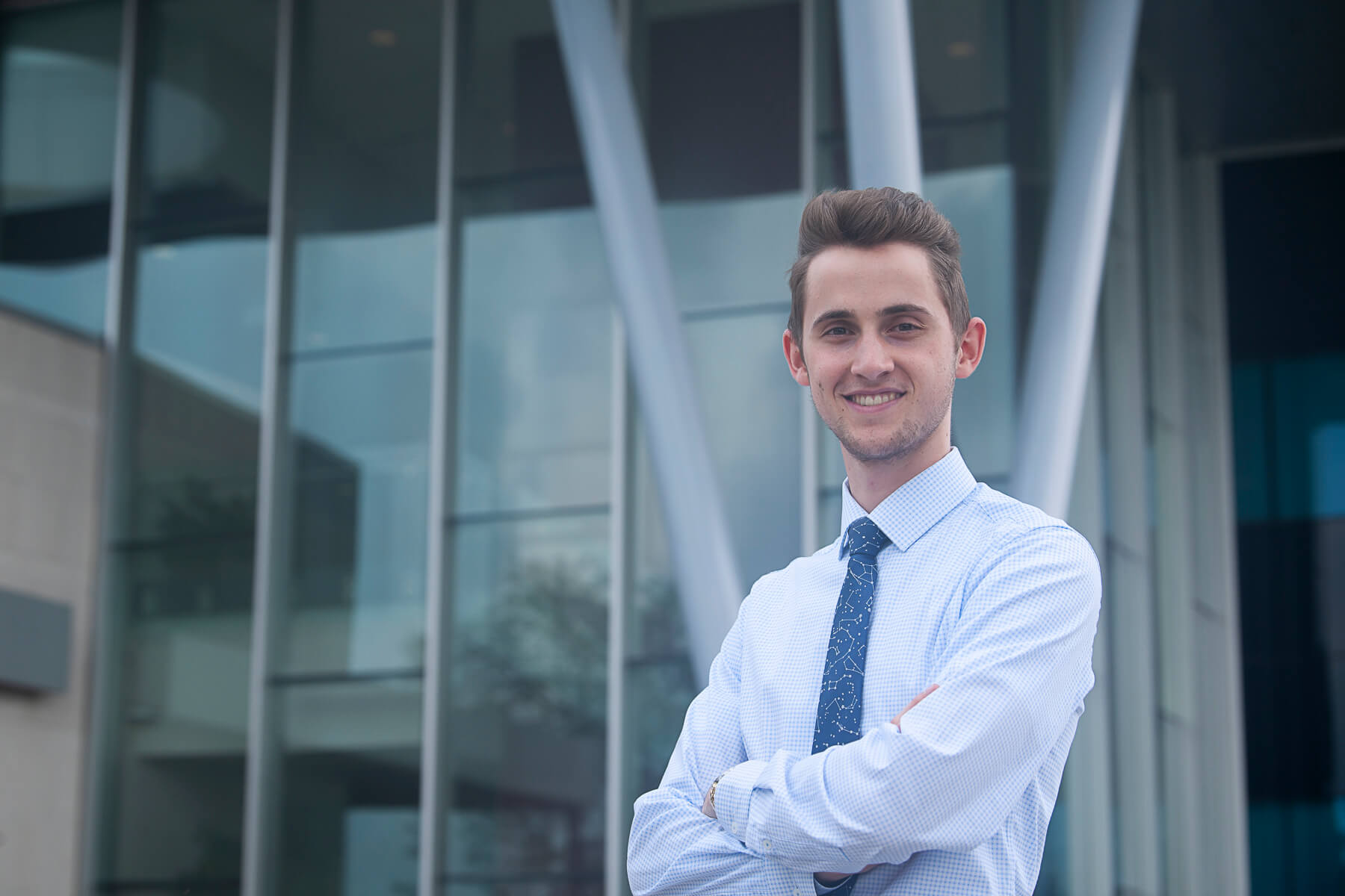 Liam Krusky posing in front of a building