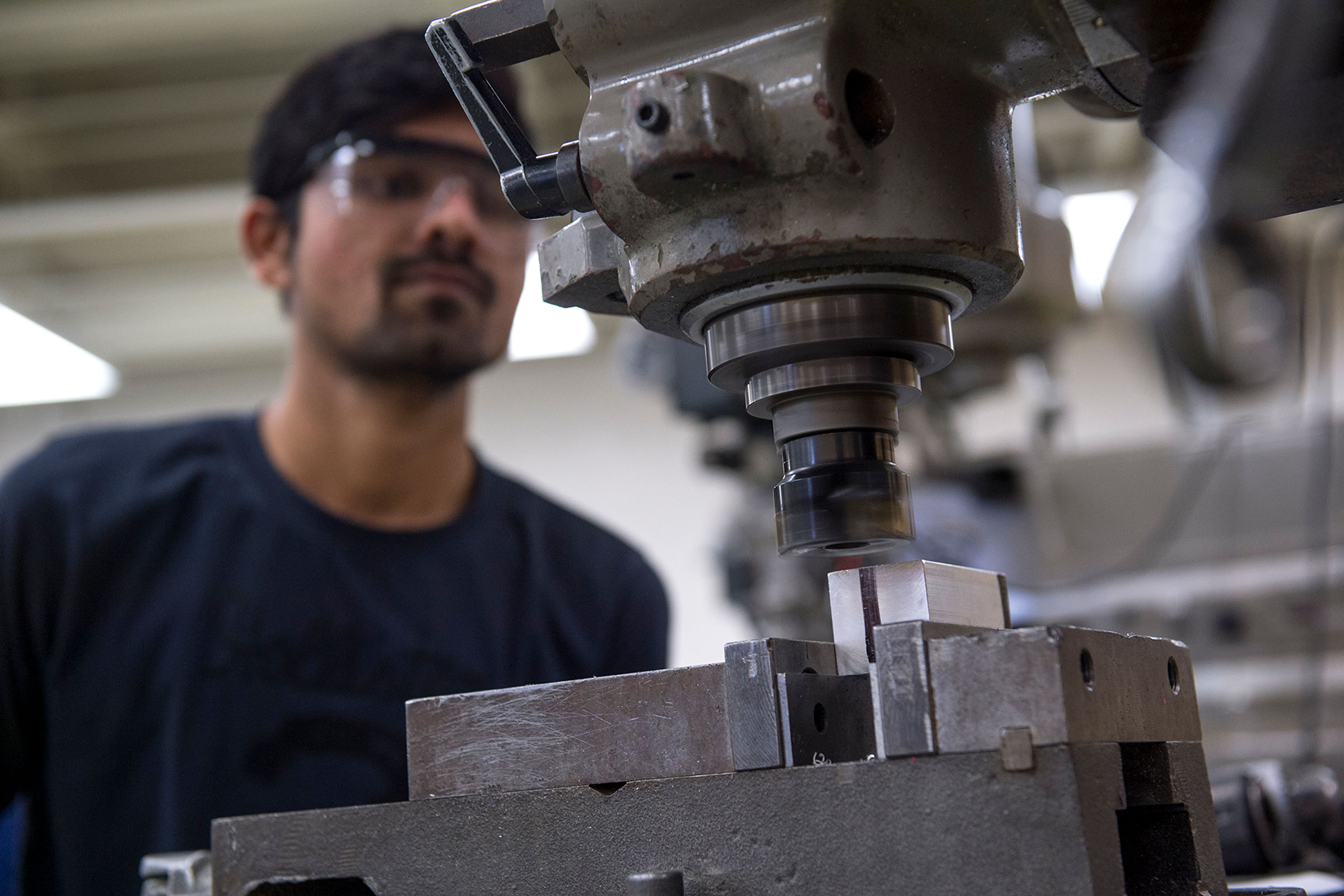 Student looking at machine in shop
