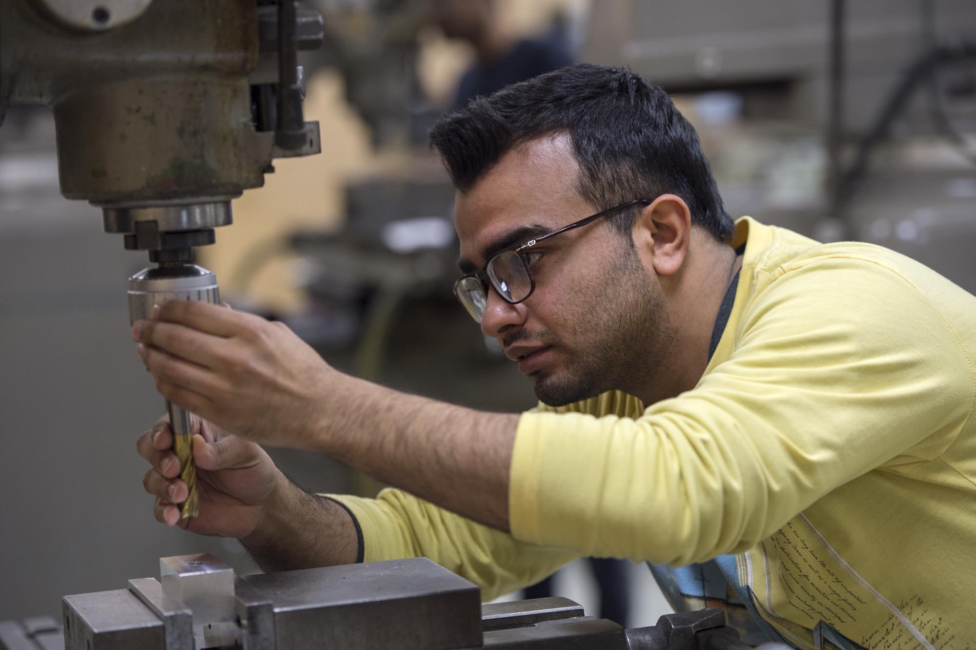 Student working on equipment in machining lab