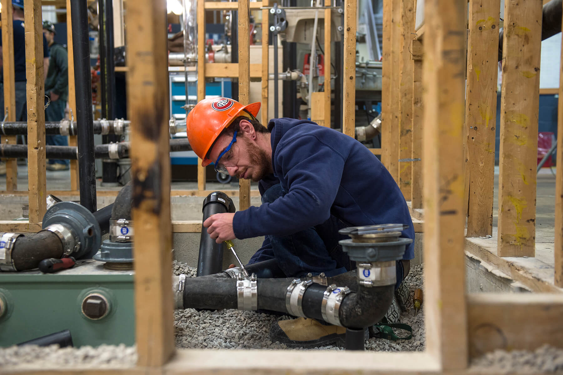 Plumbing apprentice working on a home