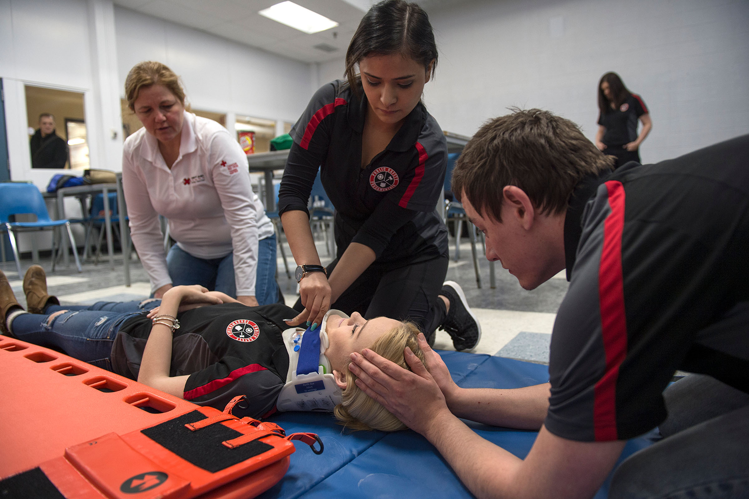 students practicing emergency neck bracing