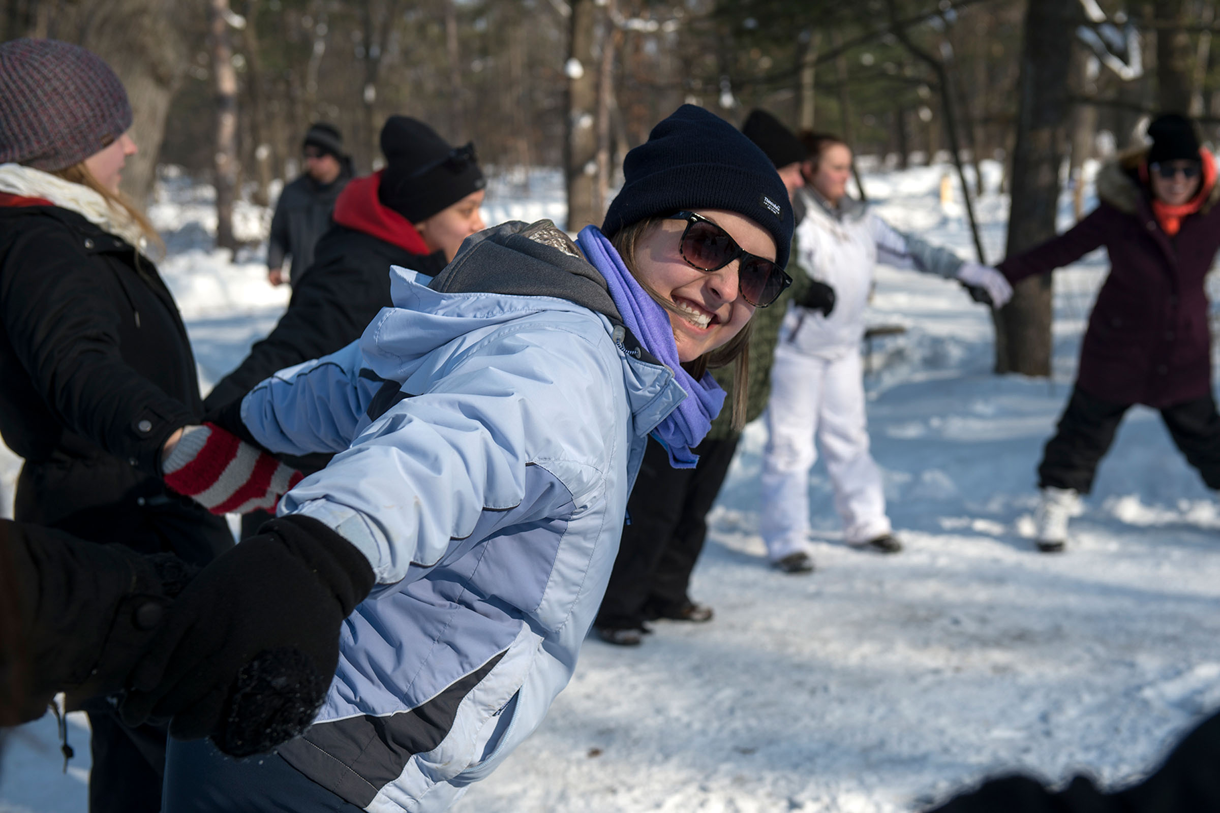 Recreation student on an outdoor trip holding hands with a group circle