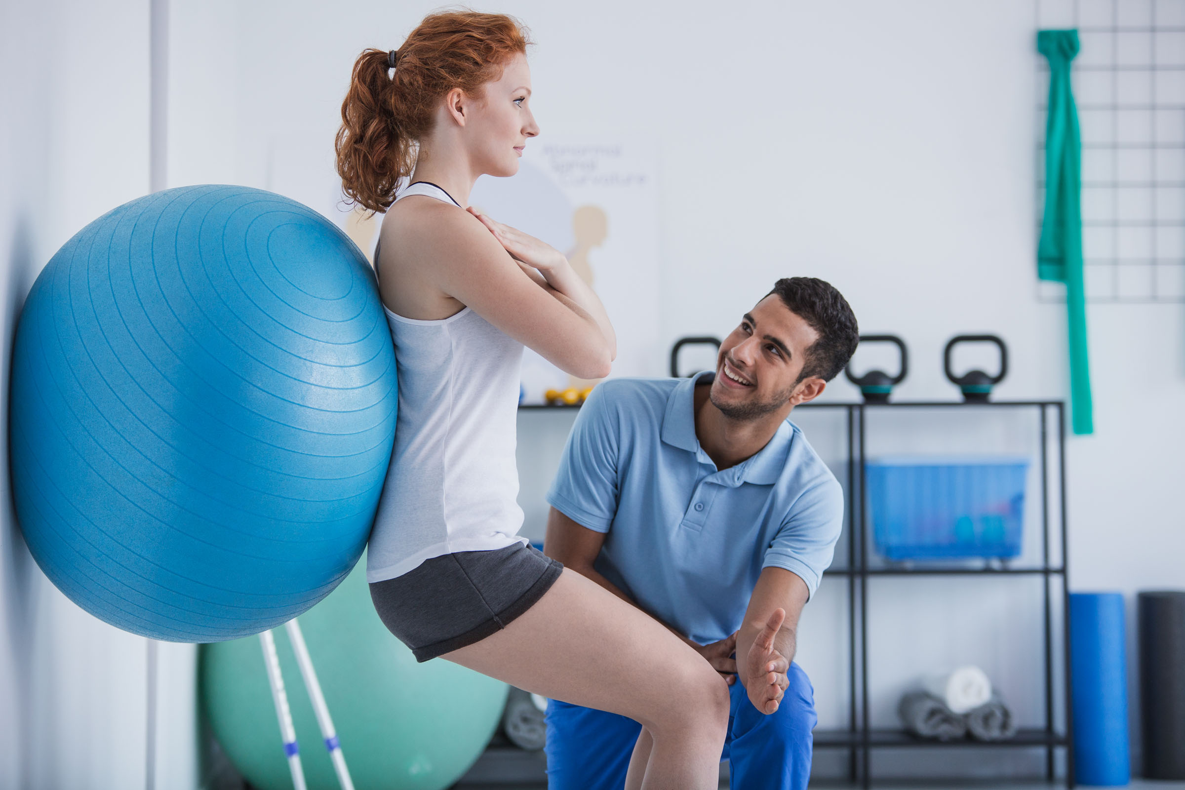 Occupational health therapist with a client showing her exercises