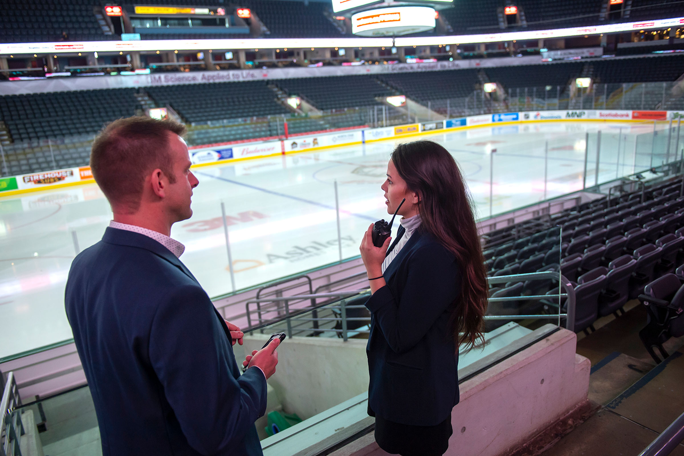 Two people in an arena in suits