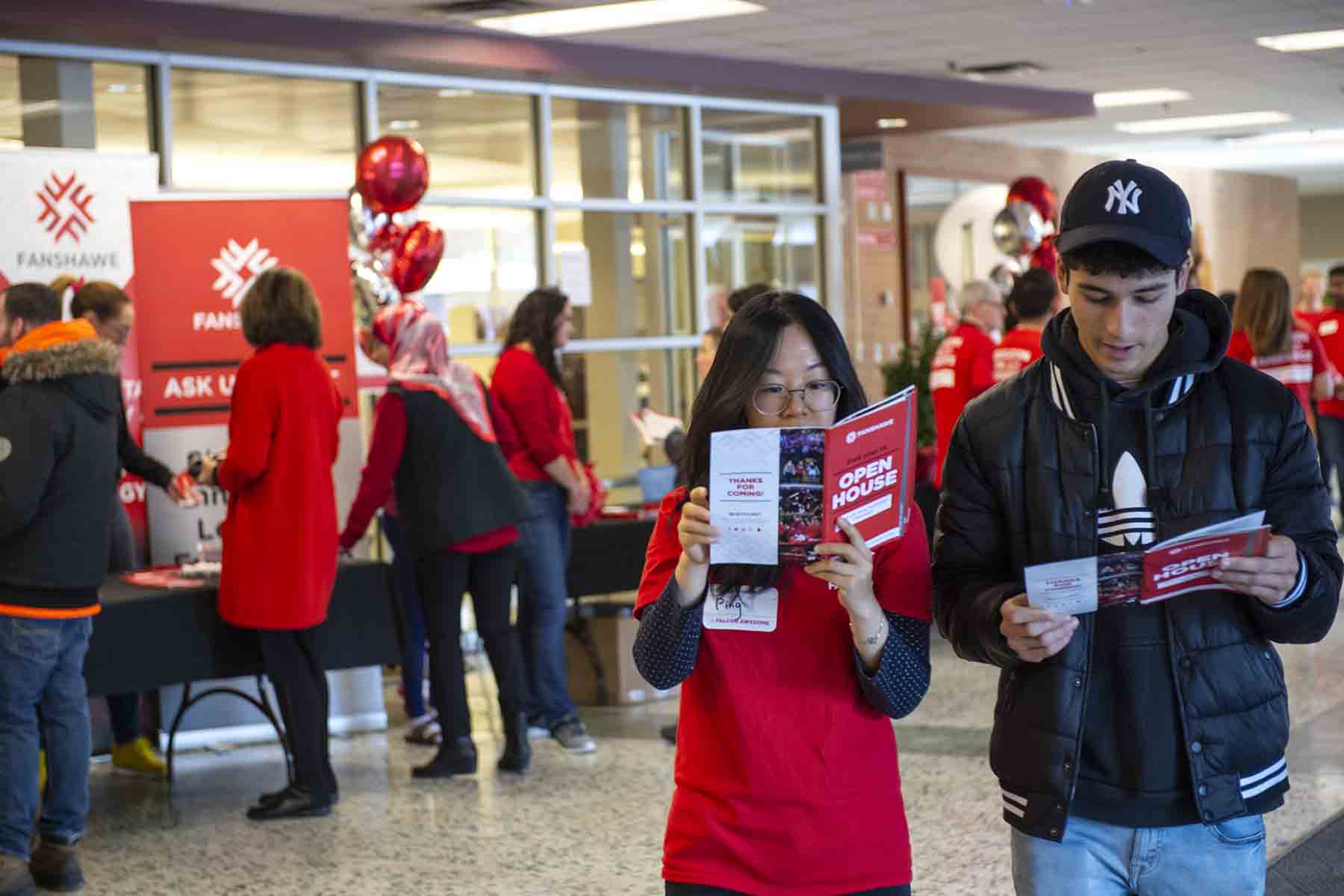 Students looking at brochure at open house