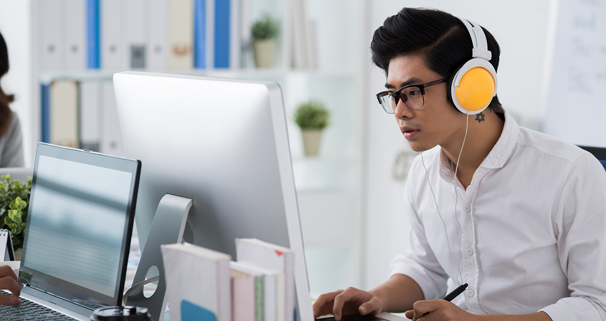 Computer programmer working at his desk