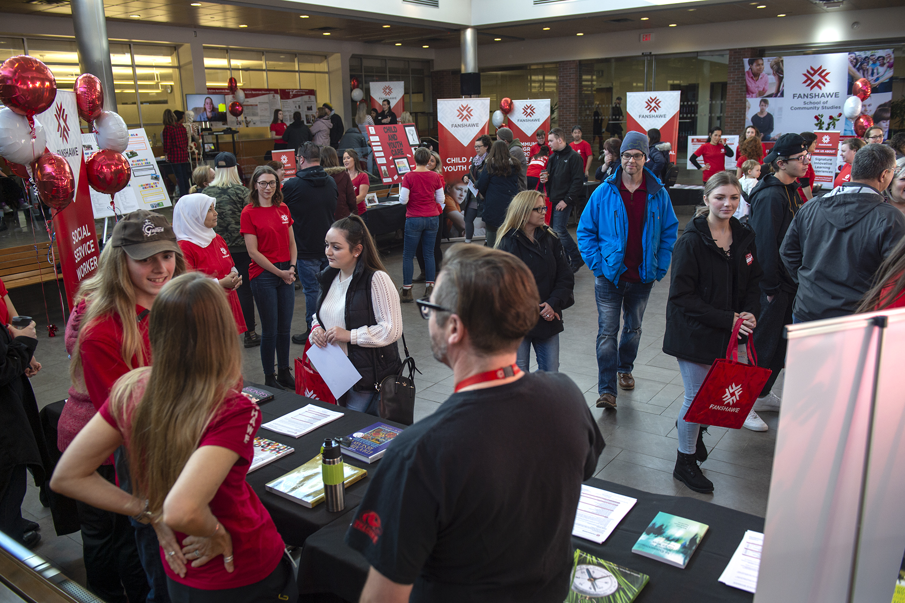 People visiting booths at open house at Fanshawe