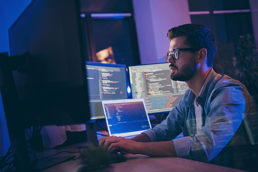 Photo of a man looking at his computer