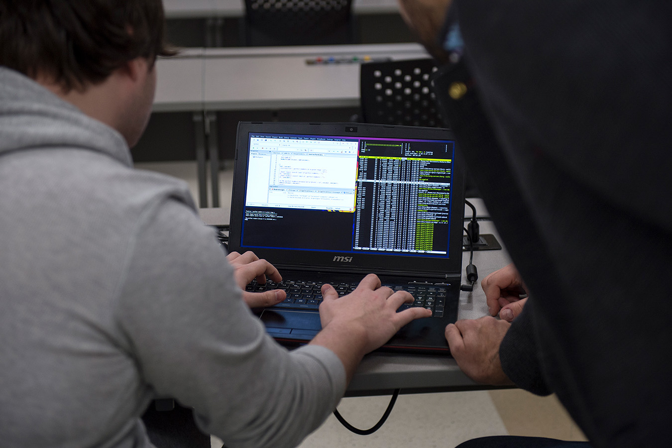 Cyber security student working on their laptop