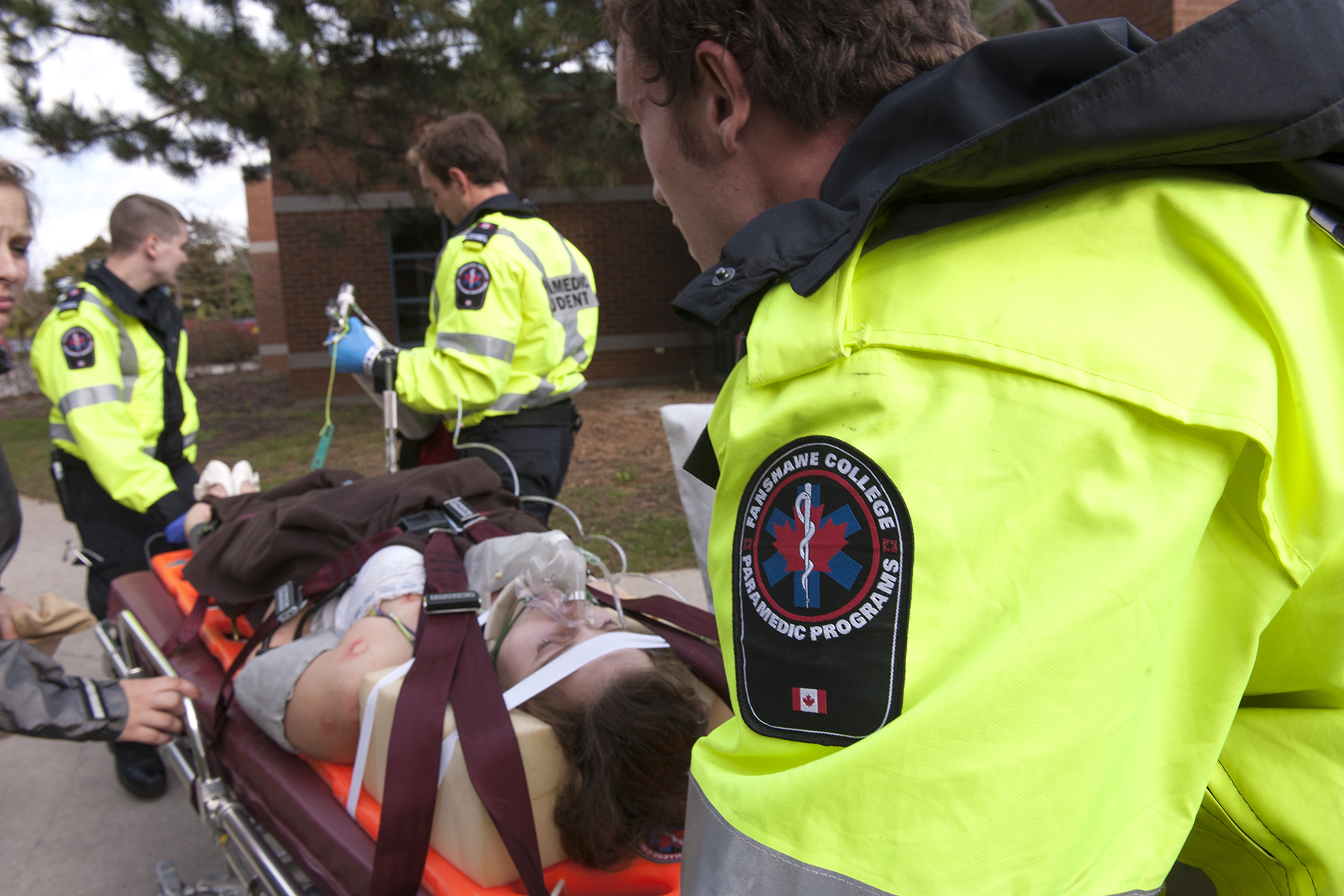 paramedic students tending to a patient during a training exercise.