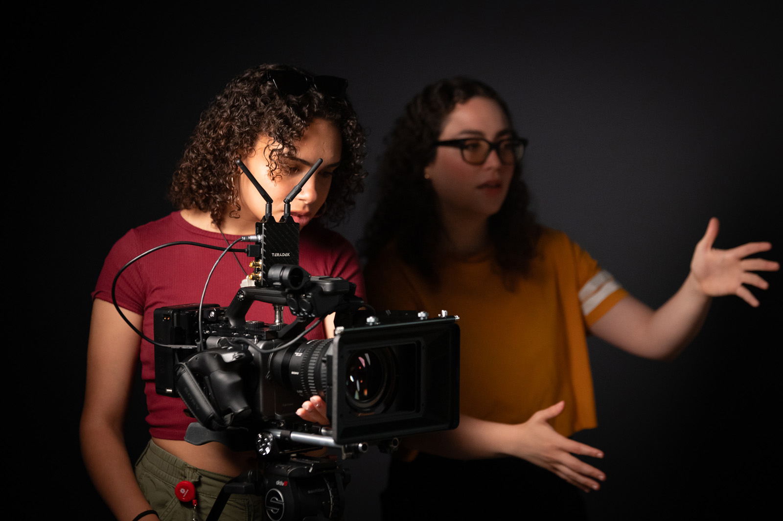 Film students look at a shot through a camera
