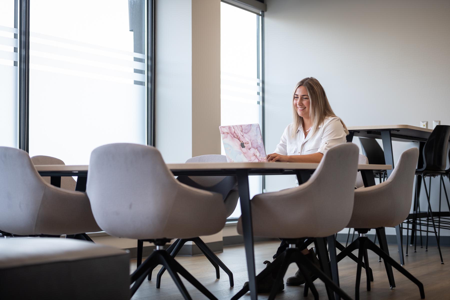 Student at laptop in an office